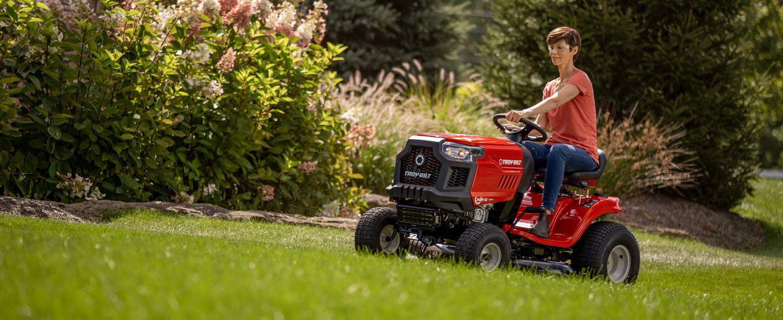 Woman mowing lawn with Troy-Bilt Lawn Tractor