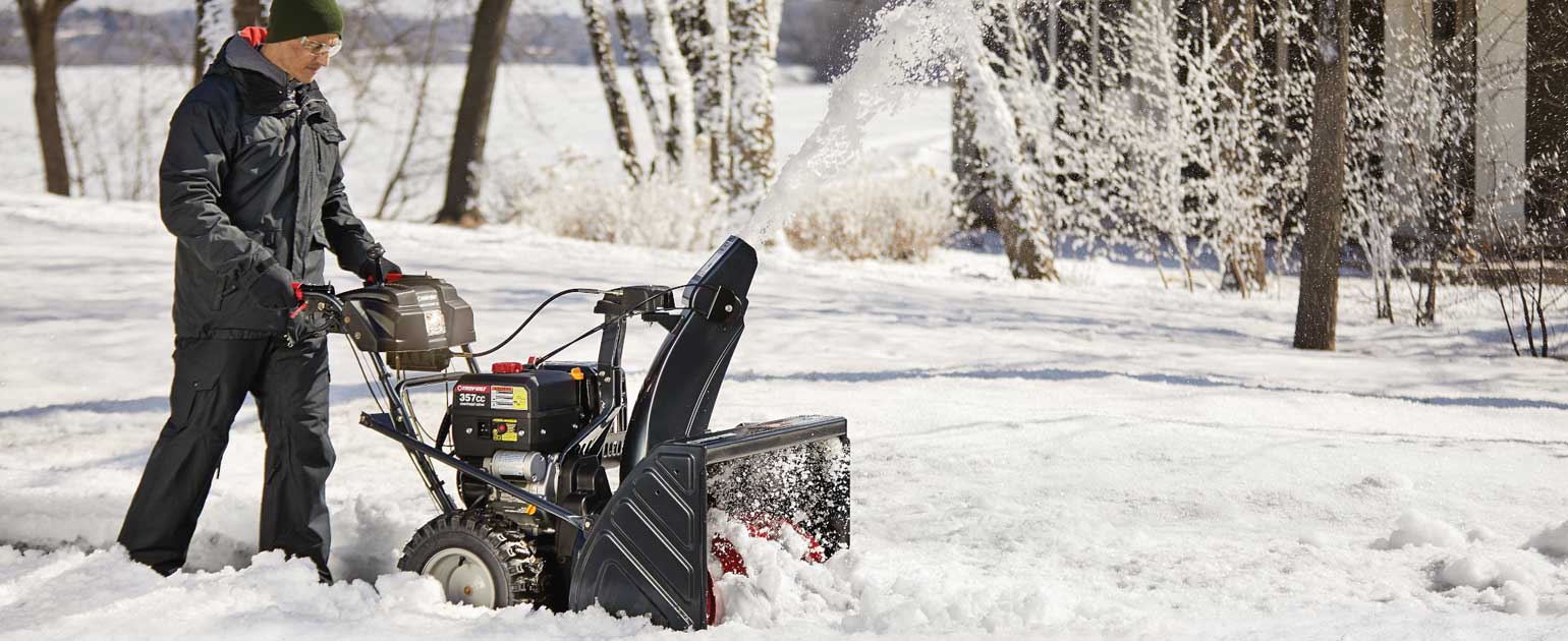 two-stage snow blower clearing driveway