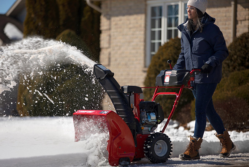 Woman clearing snow with troy-bilt snow blower