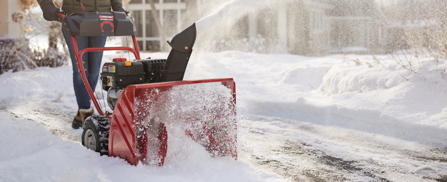 two-stage snow blower clearing driveway
