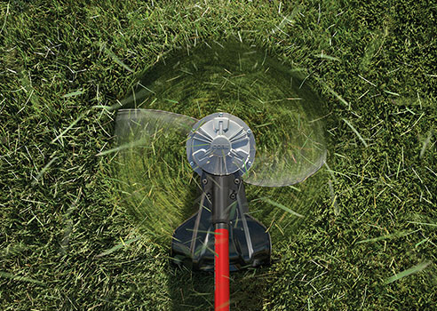 top view of string trimmer cutting an area of grass