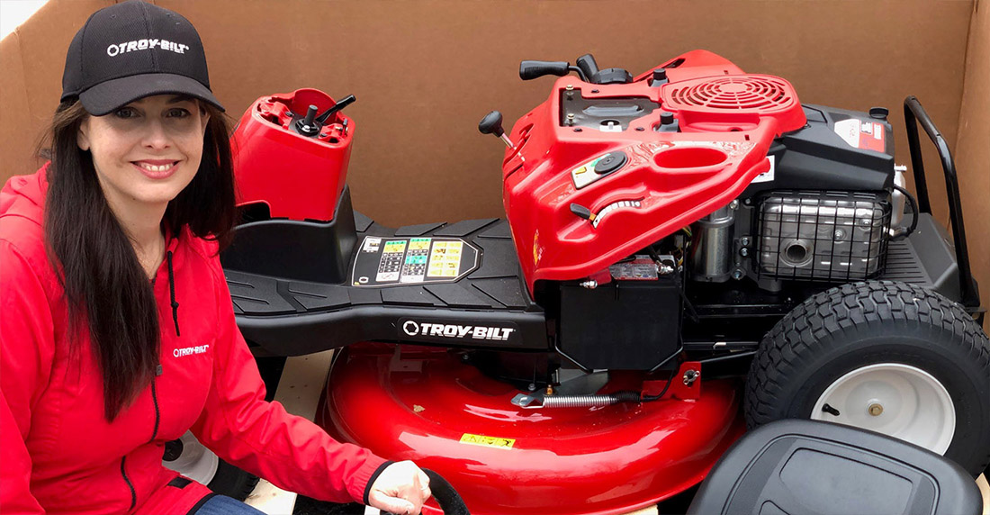 Niki Jabbour in front of new Lawn Mower in the box