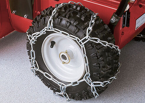 tire chains wrapped around snow blower tire